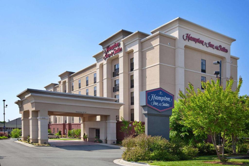 a hotel building with a sign in front of it at Hampton Inn & Suites Burlington in Burlington