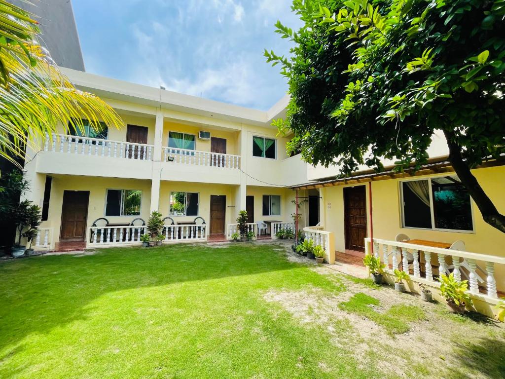 a house with a yard in front of it at FIESTA HAUS RESORT in Boracay