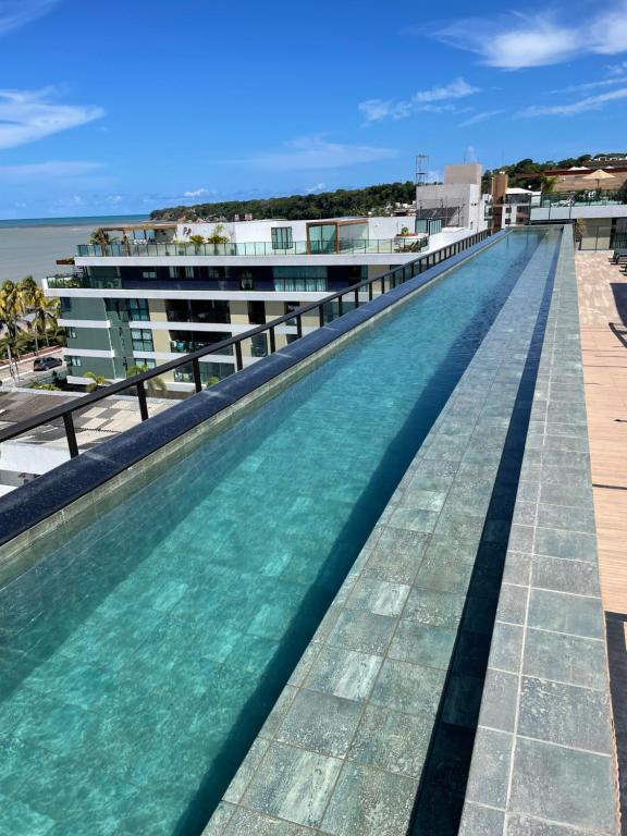 a swimming pool on the roof of a building at Flat FM20 - apt.402. Cabo Branco in João Pessoa