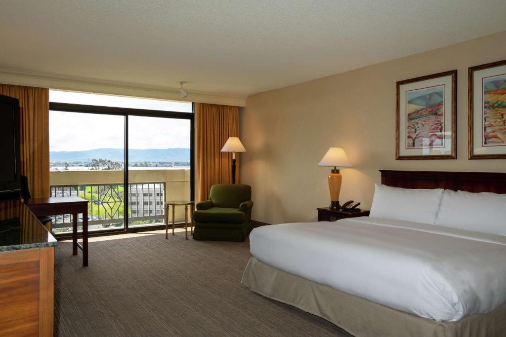 a hotel room with a bed and a large window at DoubleTree by Hilton San Jose in San Jose