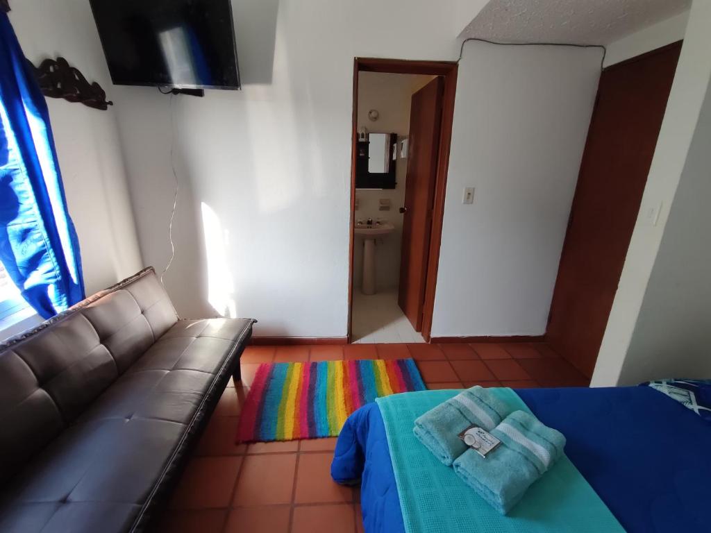 Postel nebo postele na pokoji v ubytování Hospedaje la Casa de Chavela centro histórico