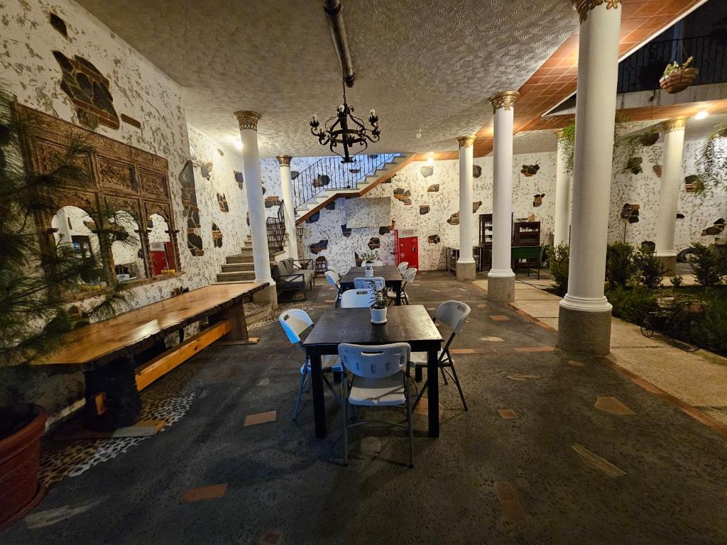a dining room with a table and chairs at LA CAPITANÍA RURAL, SAN PEDRO in Antigua Guatemala
