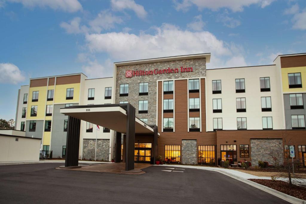 a large building with a sign that reads chiropractor inn at Hilton Garden Inn Southern Pines Pinehurst, Nc in Aberdeen