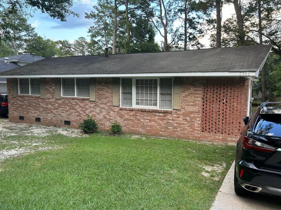 a brick house with a car parked in front of it at Home Away From Home in Columbia