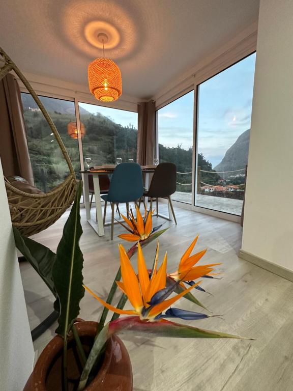 a dining room with a table and a view of the mountains at The Green Valley House in São Vicente