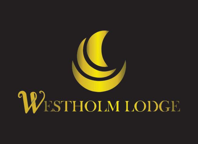 a yellow logo with a yellow moon on a black background at Westholm Lodge in Harihari