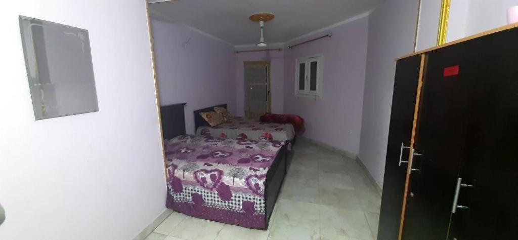A bed or beds in a room at Pyramids Hotel