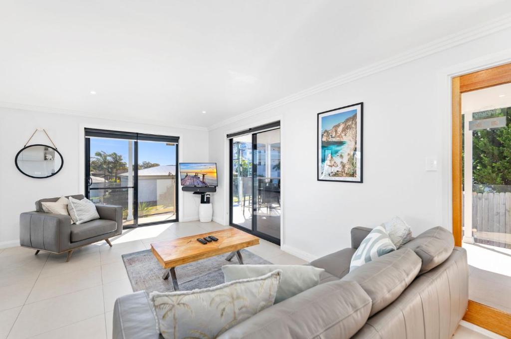 a living room with a couch and a table at Tomaree Road 16 in Shoal Bay