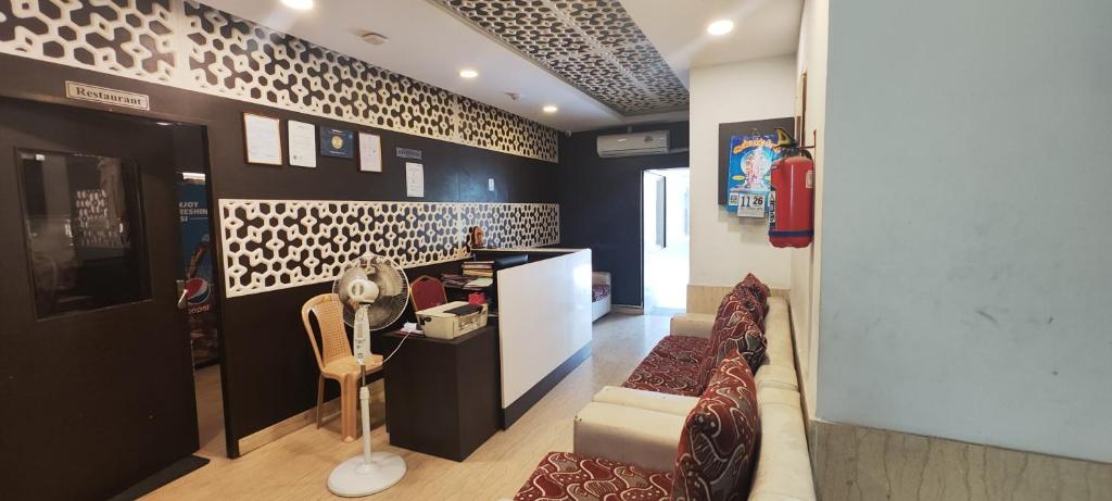 a living room with a couch and a chair at Stayz Inn Hotels - T nagar Chennai Near Pondy Bazzar in Chennai