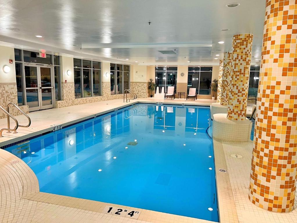 a large swimming pool in a hotel room at Chateau Inn & Suites Bonnyville in Bonnyville