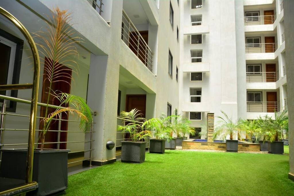 a courtyard with potted plants in a building at Relax on the high-end space in Nairobi