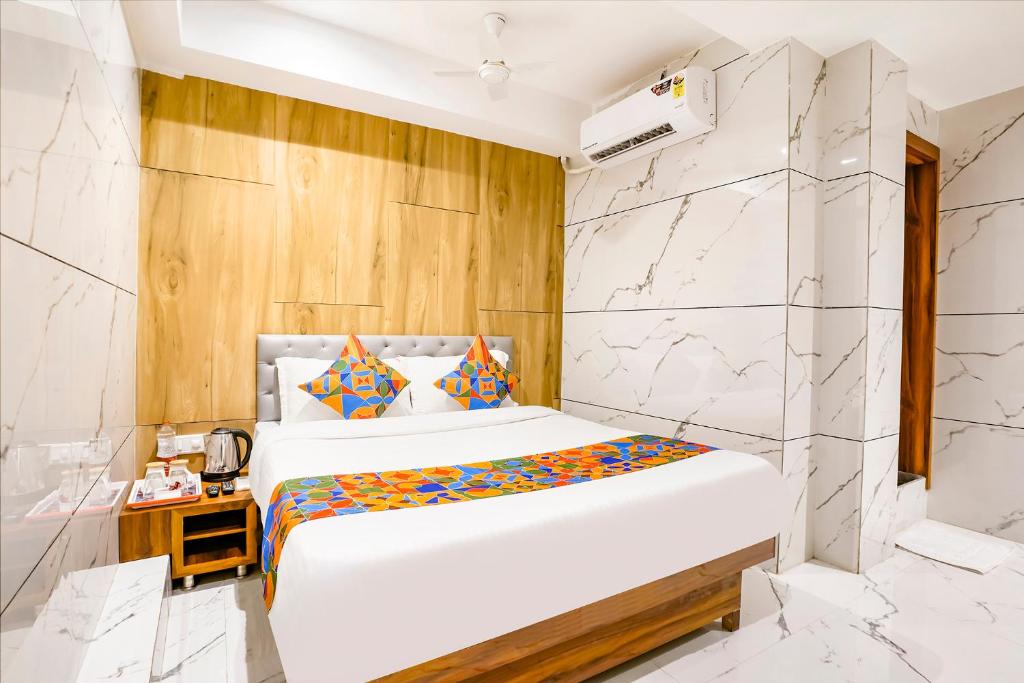 a bedroom with a bed in a room at FabHotel Shubham Inn in Mumbai