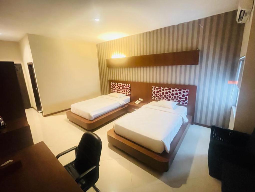 מיטה או מיטות בחדר ב-GRAND DARUSSALAM HOTEL