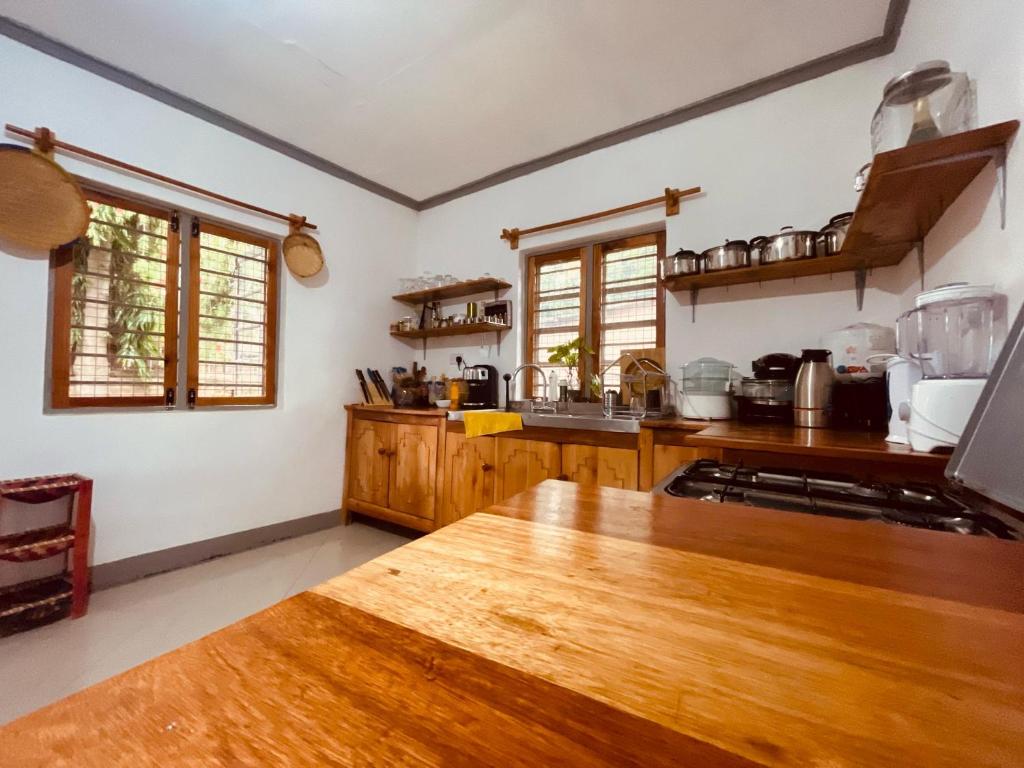 a kitchen with wooden cabinets and a wooden table at Rockville Abode in Iringa