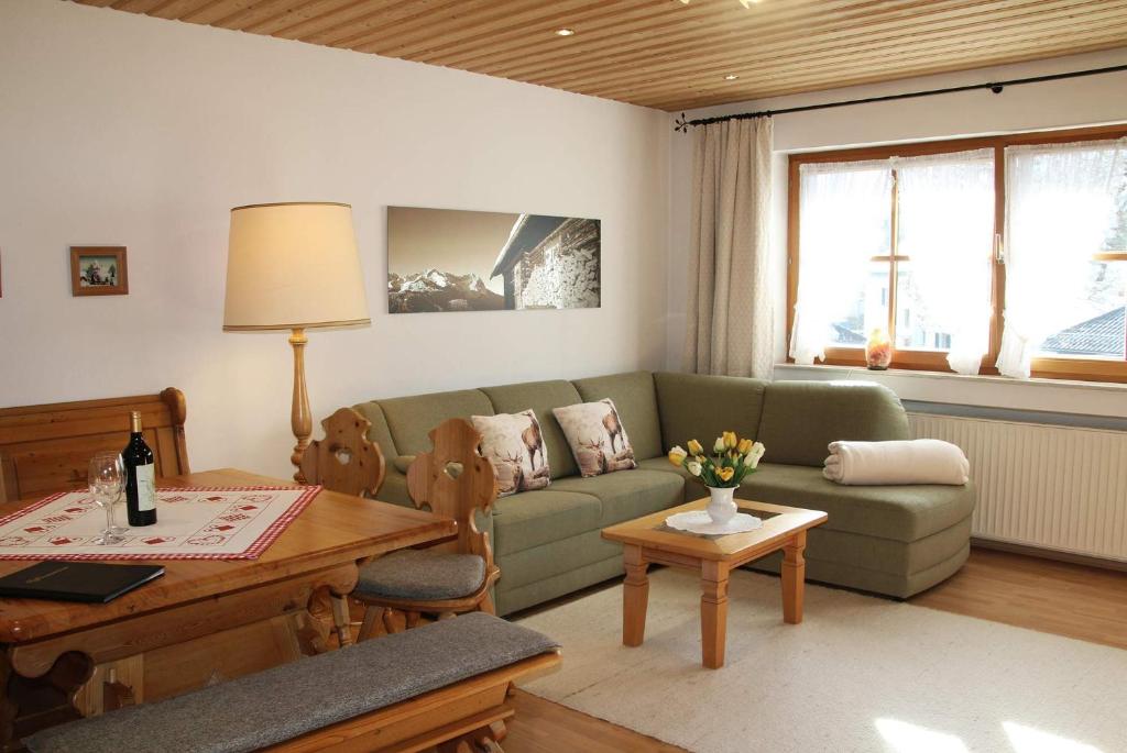 ein Wohnzimmer mit einem Sofa und einem Tisch in der Unterkunft Regina in Garmisch-Partenkirchen
