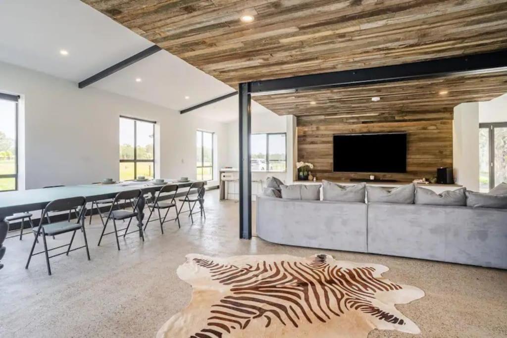 a living room with a table and a zebra rug at NEW! Charming & Spacious 4BR Retreat in Pitt Town 