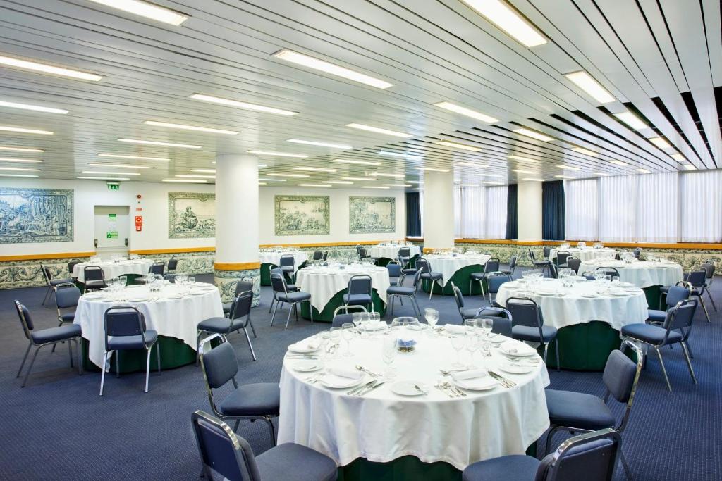 A large banquet-style dining room set with round tables and buffet service.