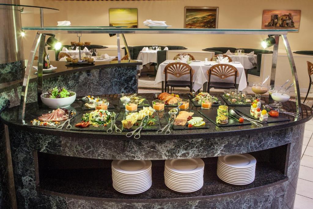 A chilled buffet display with prepared salads, fruit, and desserts.