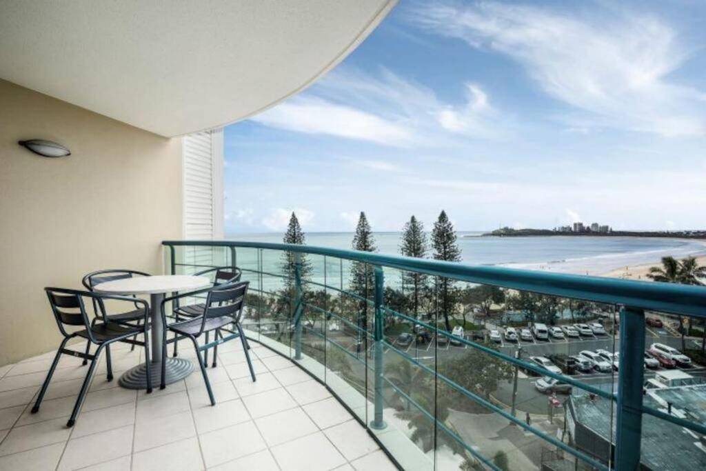 a balcony with a table and chairs and a view of the ocean at Landmark Resort Mooloolaba 4th Floor Apartment with a View in Mooloolaba