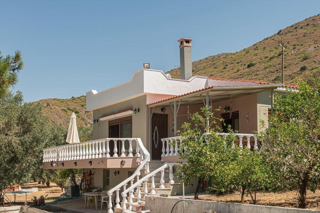 a house with a porch and a staircase in front at Villa Olive and Sea in Mytilini