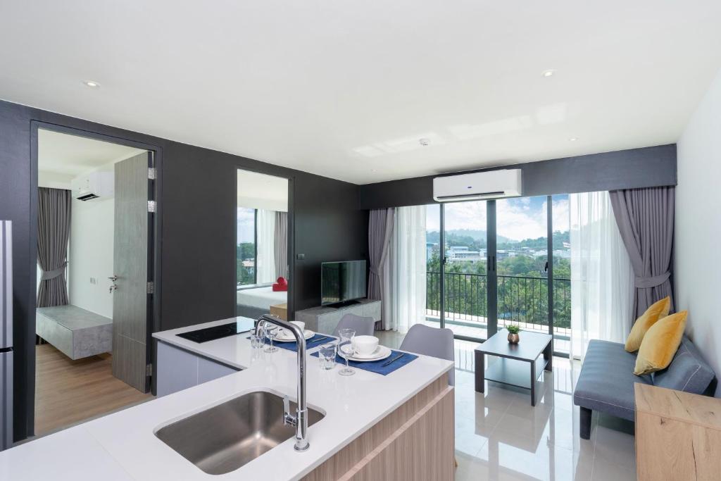 a kitchen and living room with a large window at Central Hill View Condo A716D*2BR Apartment*Ideal Location: Shopping, Relax, Adventure in Ban Ket Ho