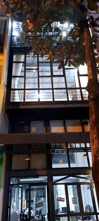 a building with windows and a motorcycle parked in it at Kidona's House in Danang