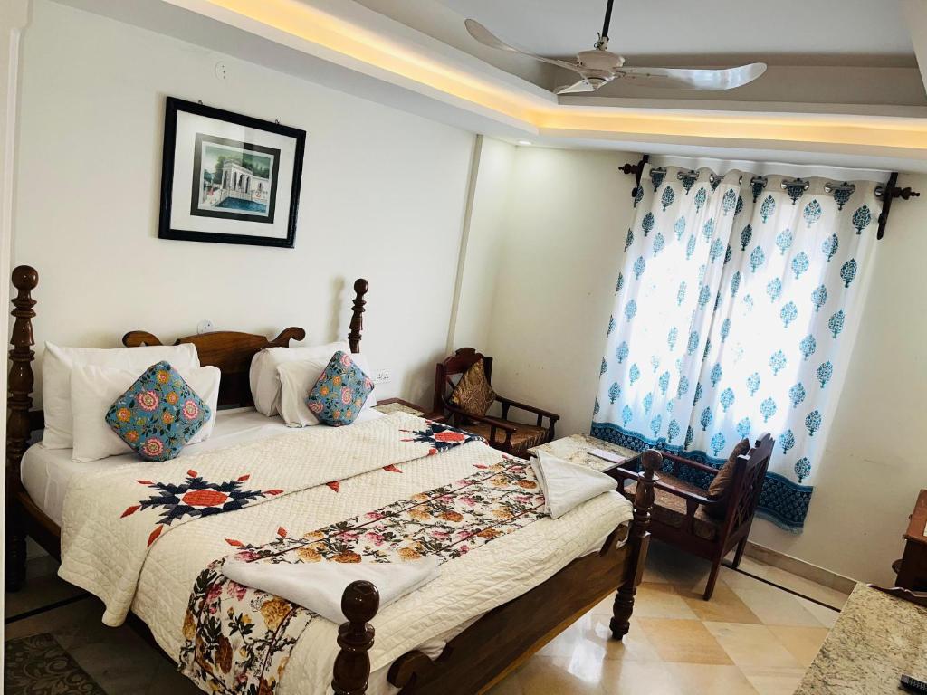 a bedroom with a large bed with blue curtains at Hotel Rime Vista in Jaipur