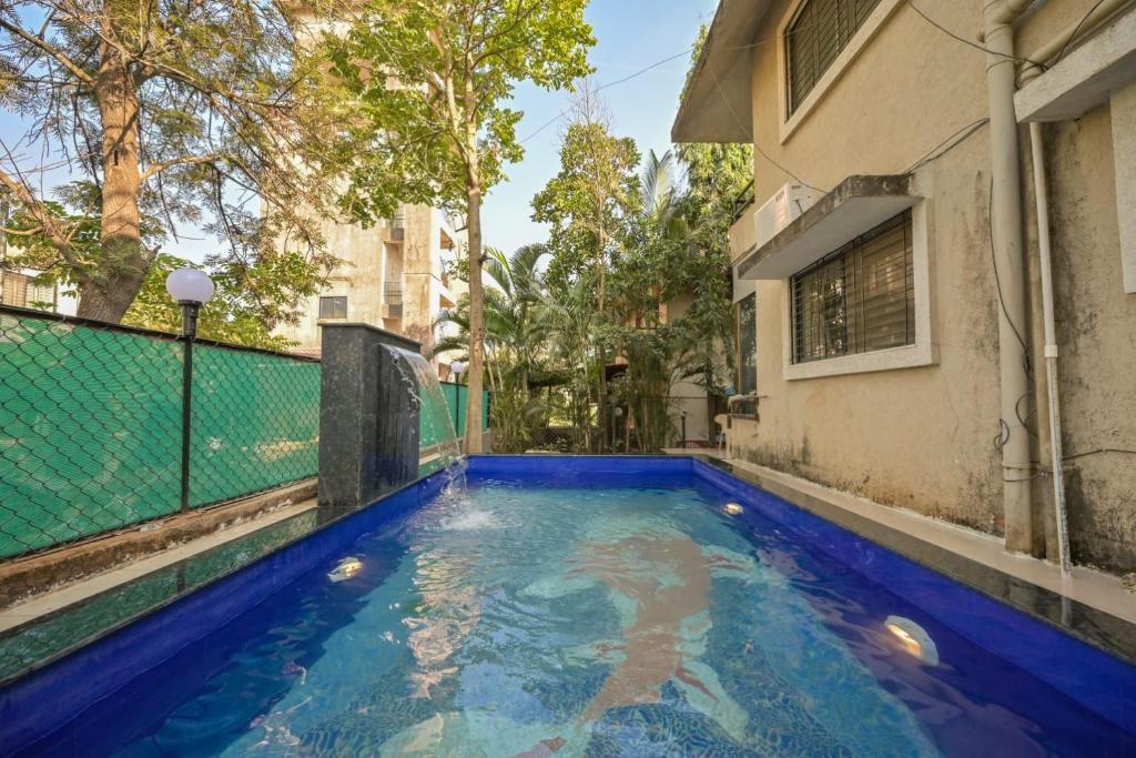a swimming pool in the backyard of a house at EMPYREAN STAY ll 2BHK ll LITTLE HOUSE VILLA ll in Lonavala