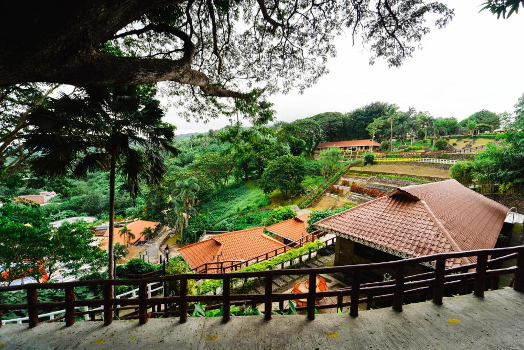 a view of a house with a fence at Sol Y Viento Mountain Hot Springs Resort in Calamba