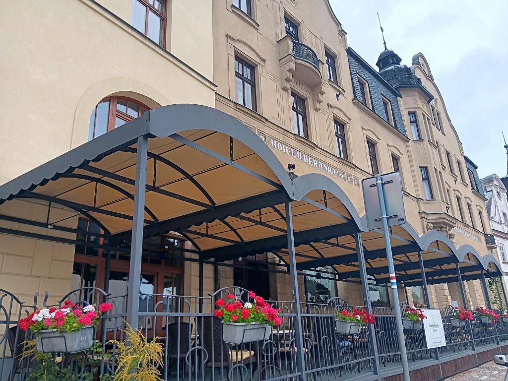 a building with awnings in front of a building at Hotel U Beránka Náchod in Náchod