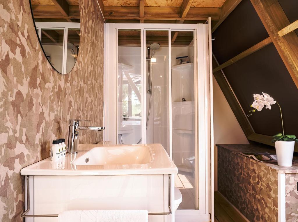 a bathroom with a sink and a mirror at Club del Sole Rimini Family Resort in Rimini