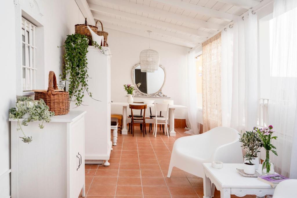 a living room with white furniture and a table at Terrazza Maté in Molfetta