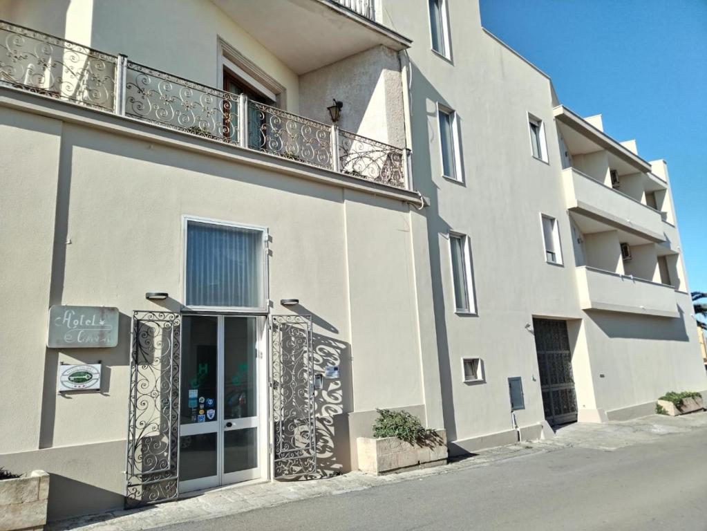 a building with a balcony on the side of it at Hotel Colibrì in Alessano