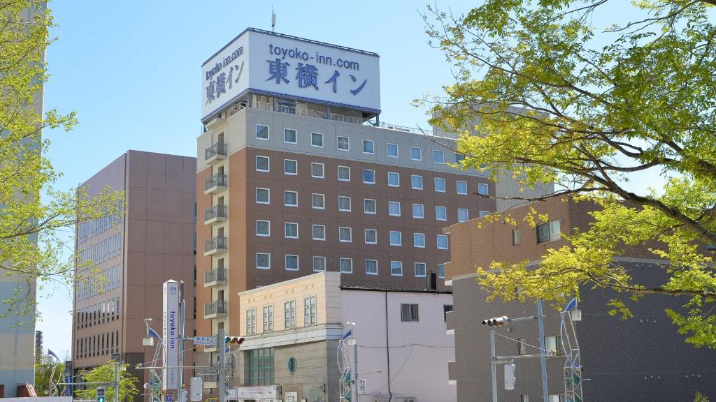 a building with a clock tower on top of it at Toyoko Inn Hokkaido Tomakomai Ekimae in Tomakomai