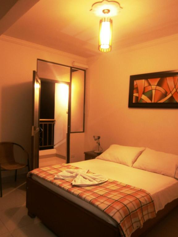 Postel nebo postele na pokoji v ubytování Hotel Shalom PHE Guaduas