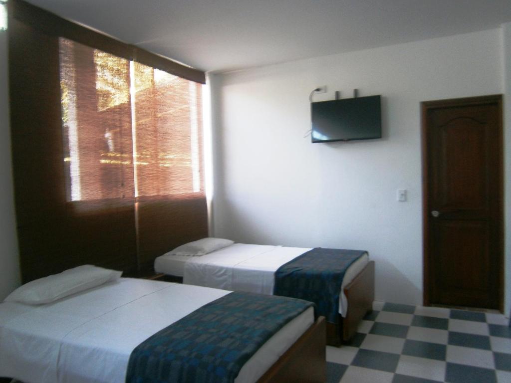 Postel nebo postele na pokoji v ubytování Hotel Shalom PHE Guaduas