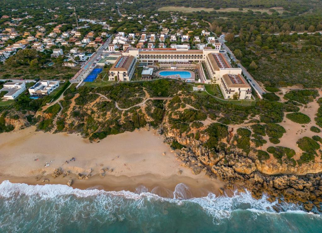 an aerial view of a mansion on the beach at Ilunion Calas de Conil in Conil de la Frontera