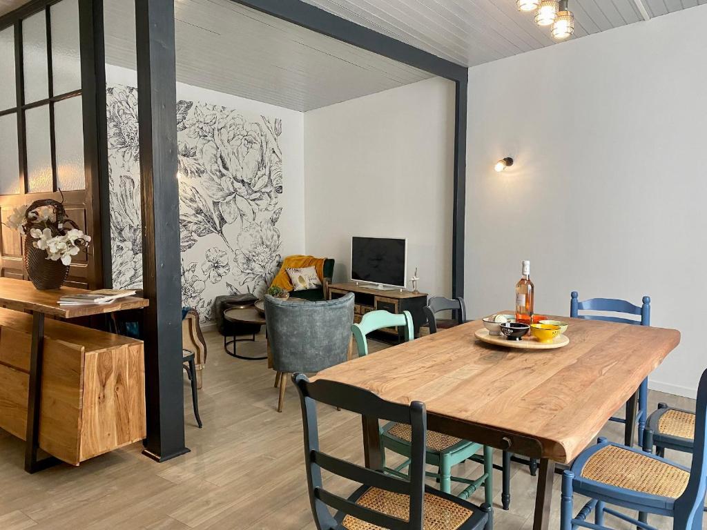 une salle à manger avec une table et des chaises en bois dans l'établissement Charmant Duplex Rénové au Cœur de St Joachim, proche Parc de Brière et Plages - FR-1-306-1222, à Saint-Joachim