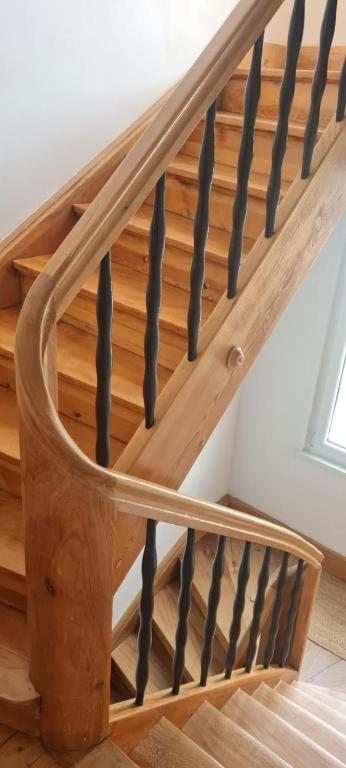 a wooden staircase with wooden treads in a house at Appartement de charme proche de Colmar in Horbourg