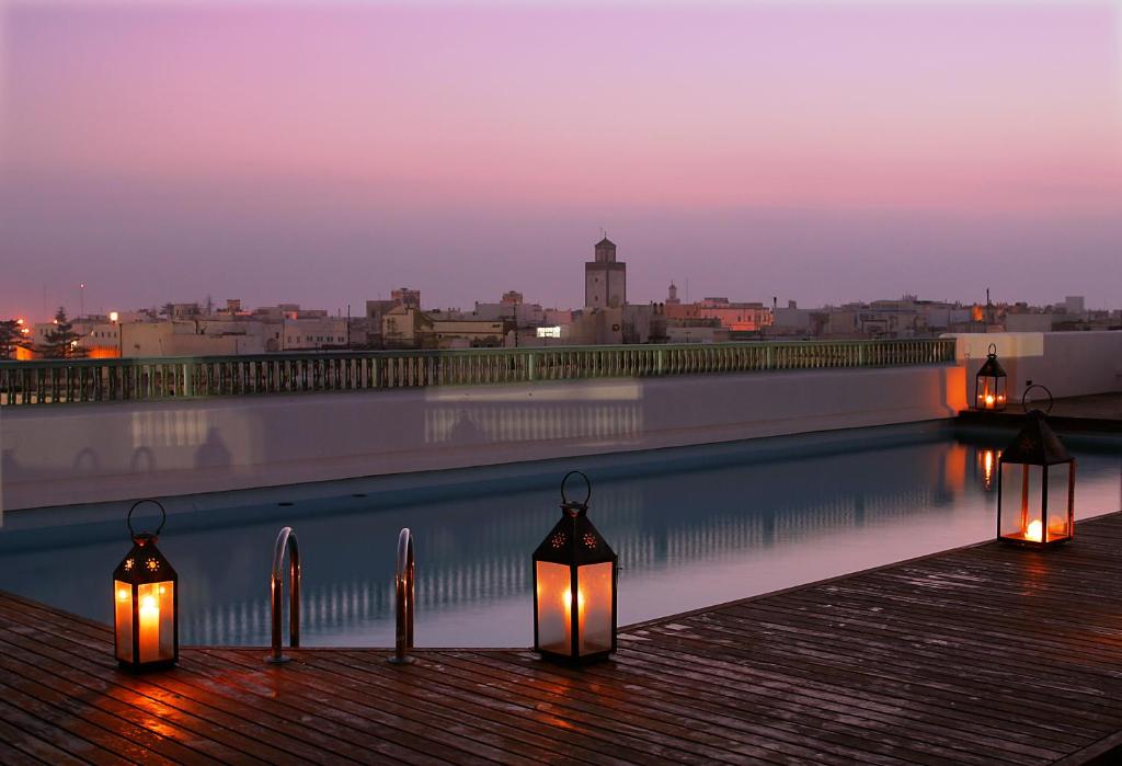 a row of tall buildings with lights on at night at Heure Bleue Palais - Relais & Châteaux in Essaouira