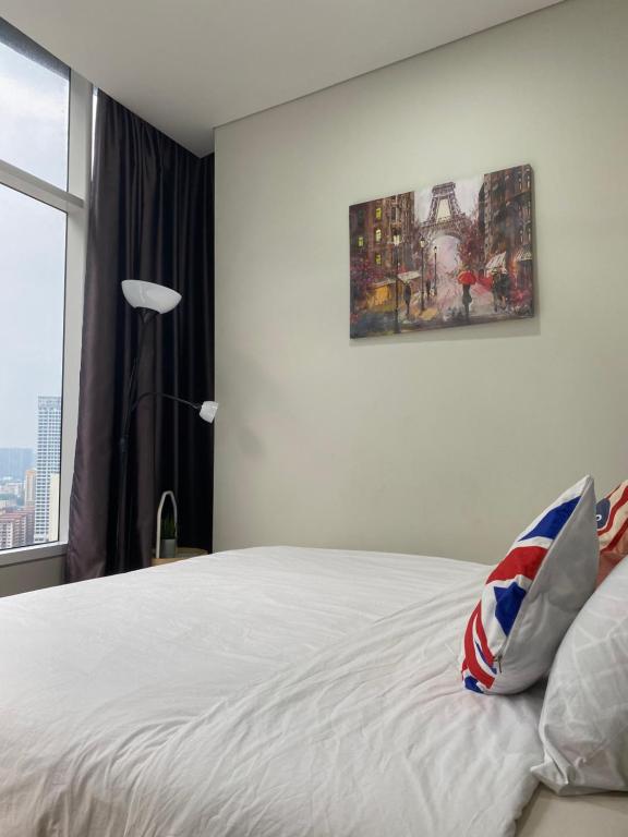 a bedroom with a white bed and a window at sky suite klcc in Kuala Lumpur