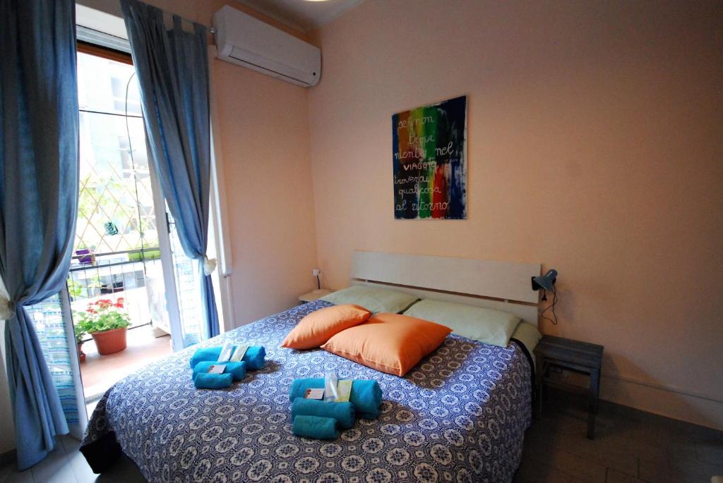 a bedroom with a bed with blue pillows and a window at Lovely 1-Bedroom Apartment in Lingotto Area in Turin