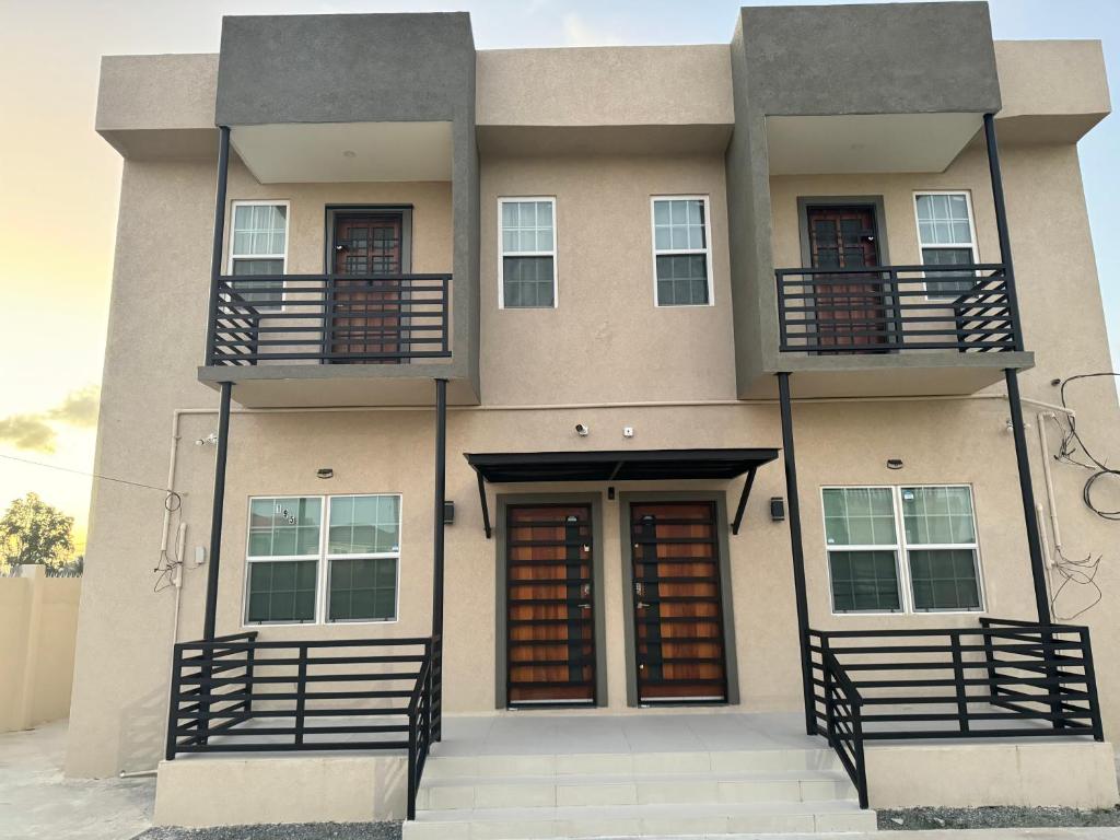 a building with a door and a balcony at A modern townhouse at Farm in Georgetown