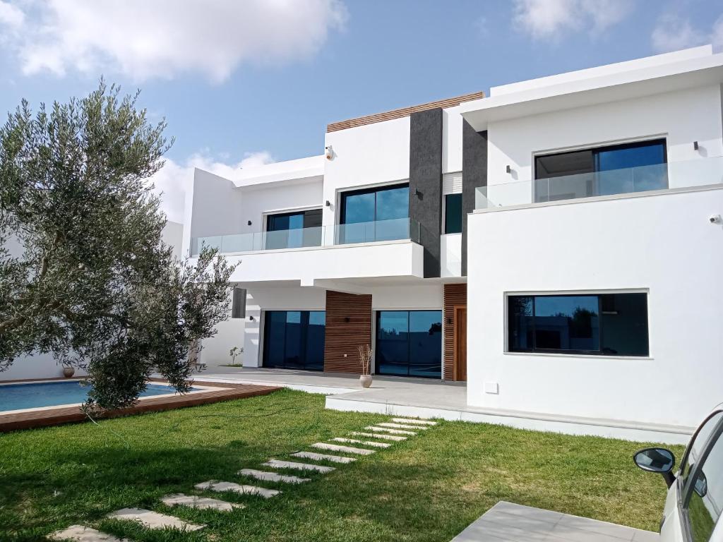 a white house with a yard at Villa Jayzy in Hammamet