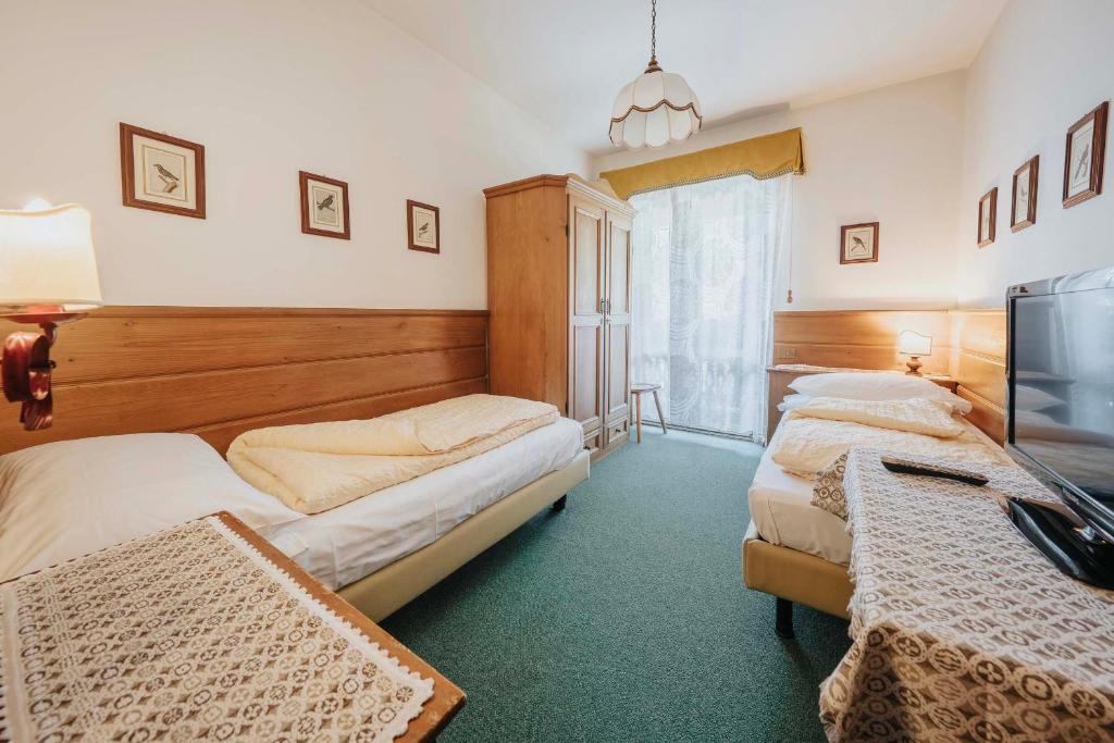 Кровать или кровати в номере Hotel Menardi
