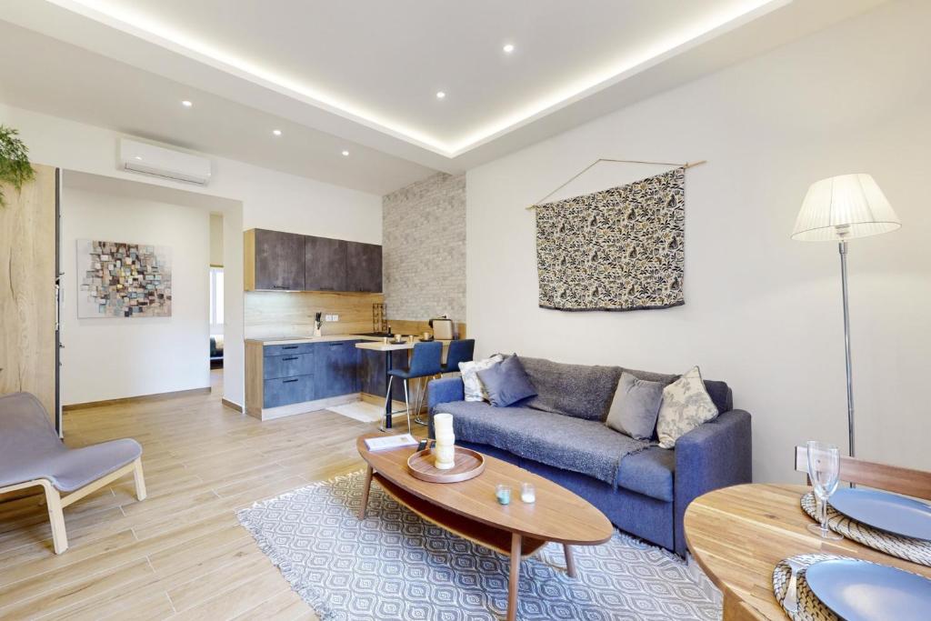 un salon avec un canapé bleu et une table dans l'établissement Suite Stars FSHH, à Nice