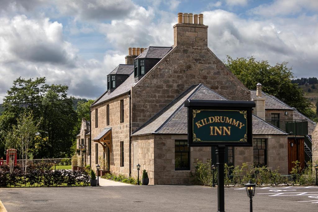 a building with a sign in front of it at Kildrummy Inn in Kildrummy