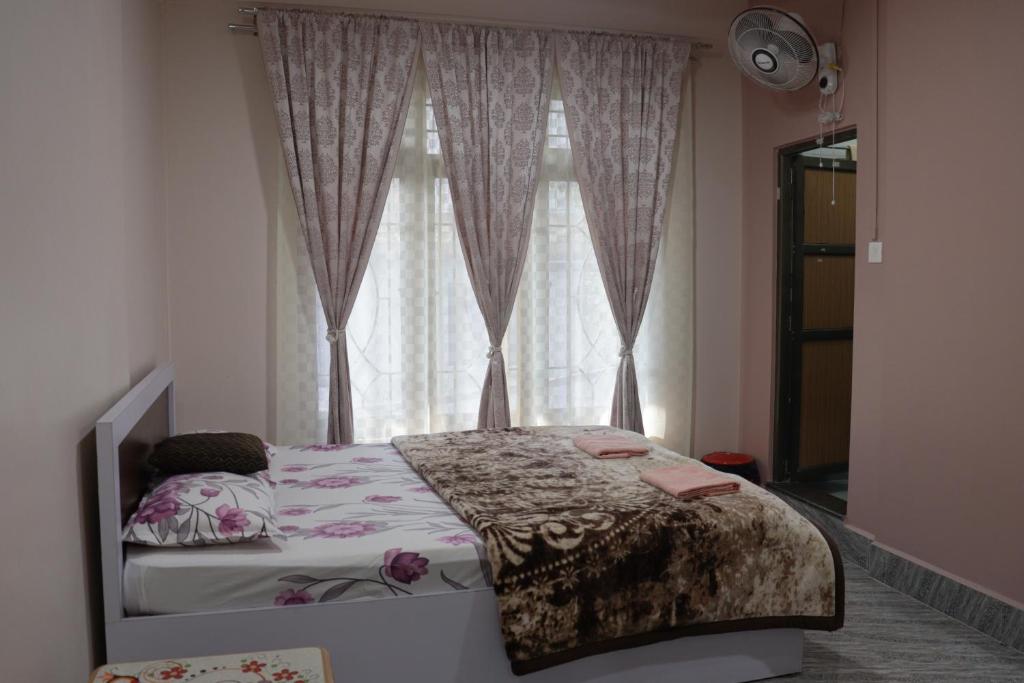 a bedroom with a bed in front of a window at Apurna Guest House Dawki in Dawki