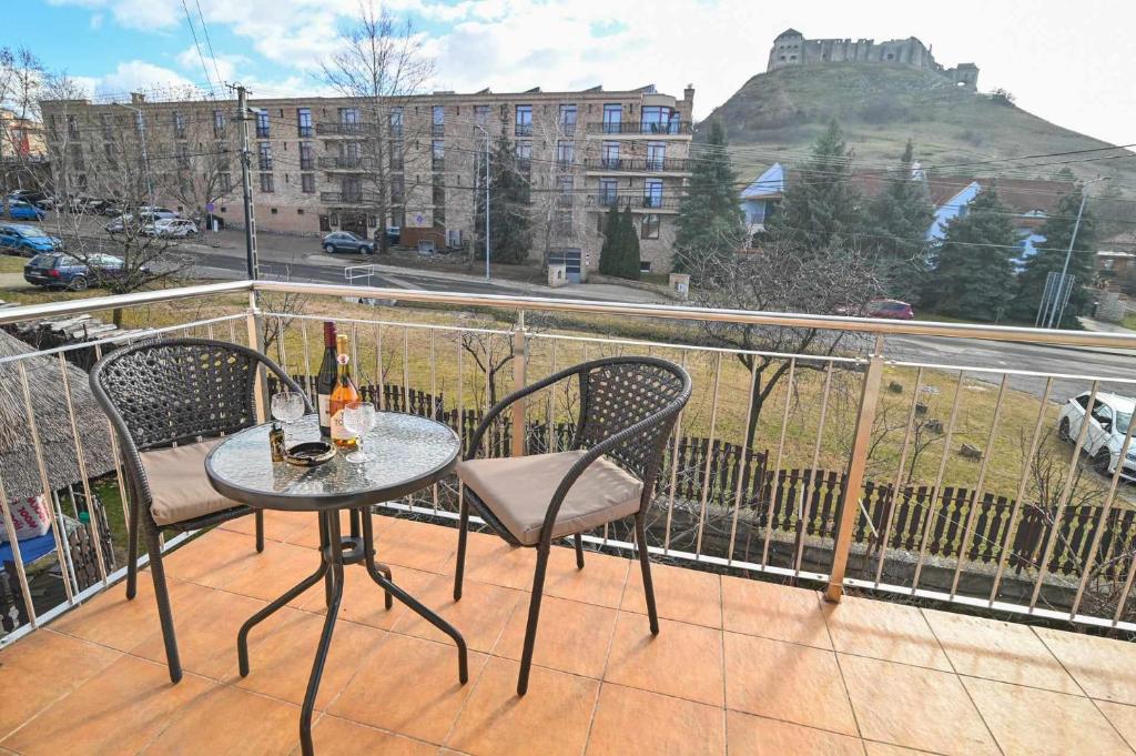 a table and chairs on a balcony with a view at Vár-Lak Apartman in Sümeg