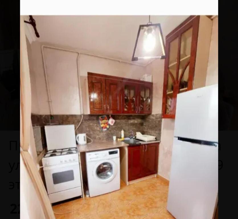 a kitchen with a white stove and a refrigerator at Квартира в центре Еревана in Yerevan